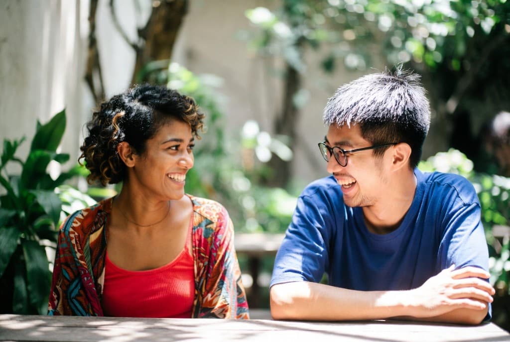 Two people having a friendly conversation outdoors