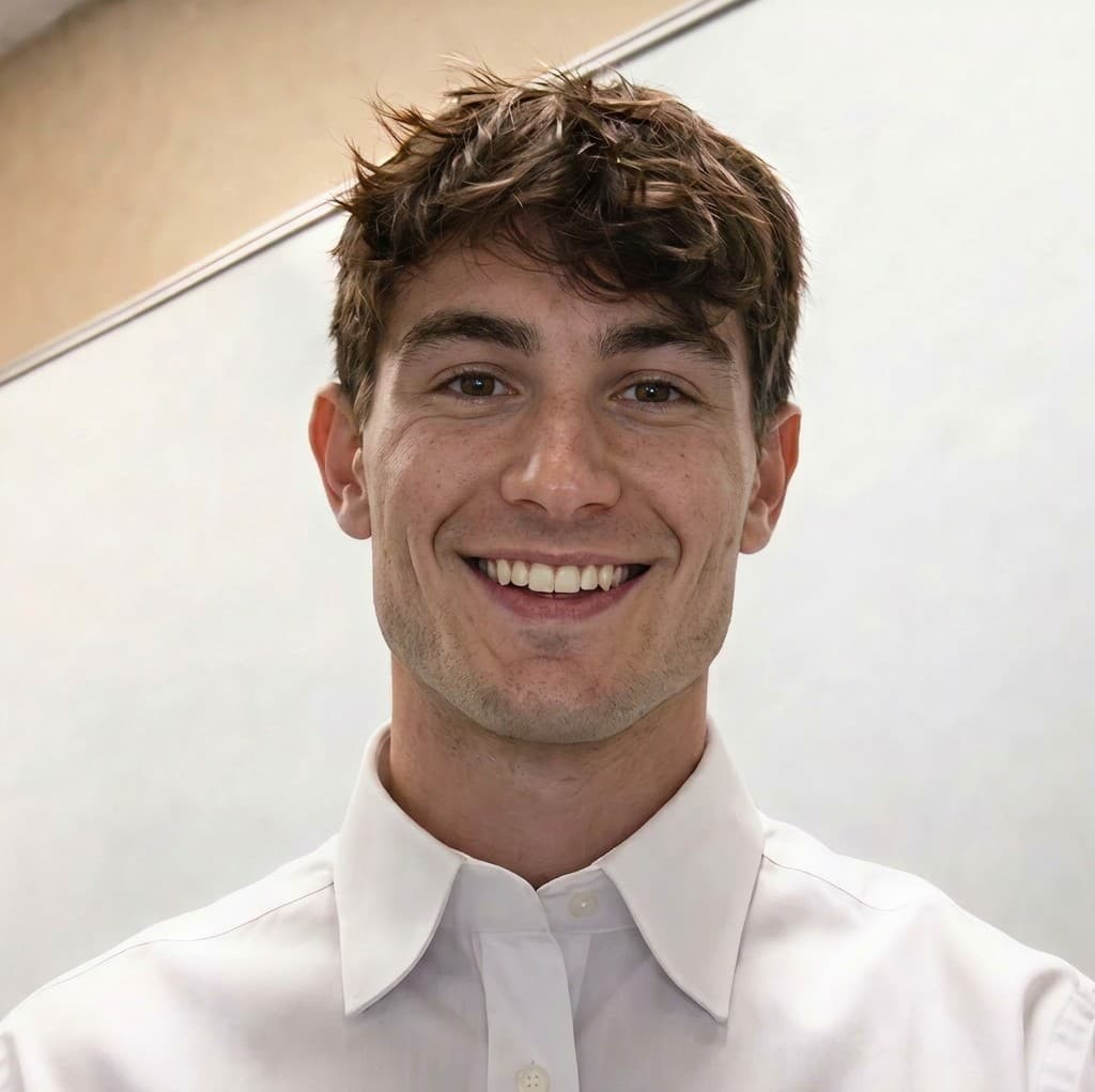 Young man smiling in white shirt